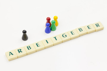 Eine Gruppe bunter Spielfiguren steht einer schwarzen Figur gegenüber, Sinnbild für das...