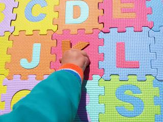 Child playing and learning with colorful puzzles.