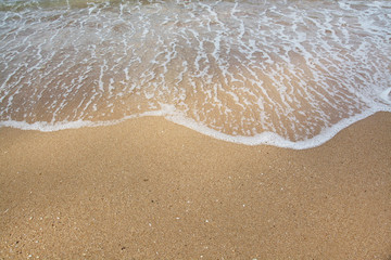 Fototapeta na wymiar Sea waves and sandy beach background