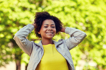 happy african american young woman in summer park