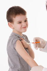 Doctor giving a child injection in arm on isolated image.