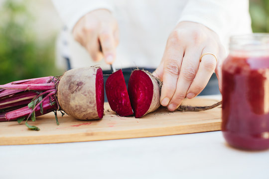 Close-up of hands preparing a beet juice