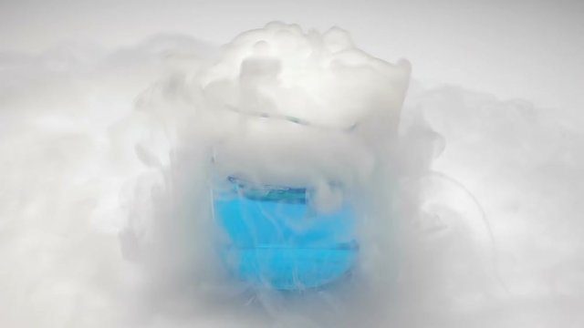 Putting dry ice in blue liquid in beaker. Dry ice steam.