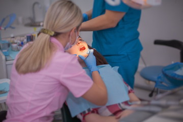 Girl patient at a reception at the dentist.