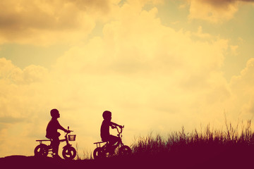 two little boys bike silhouette