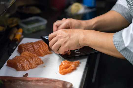 chef arrange salmon sashimi