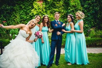 Bridesmaids, groom and his funny wife