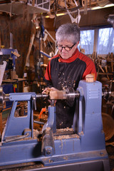 Fototapeta na wymiar Woodturners using a rotating clamp to turn the wood.