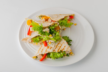 Quesadilla with chicken and corn on a round plate