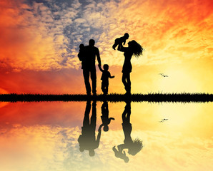 joyful family at sunset