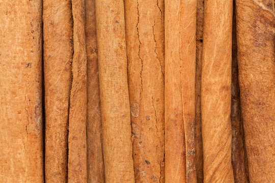 Organic Cinnamon sticks (Cinnamomum verum). Macro close up background texture. Top view.