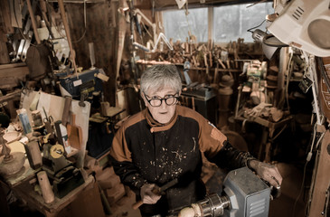 Woodturners using a rotating clamp to turn the wood.