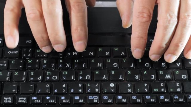 The man was typing something into his laptop