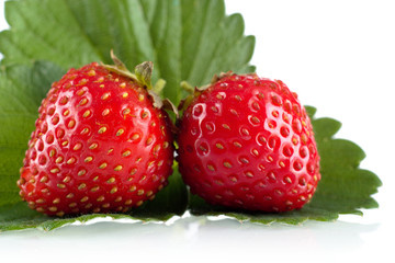 Whole strawberries with leaves on a white