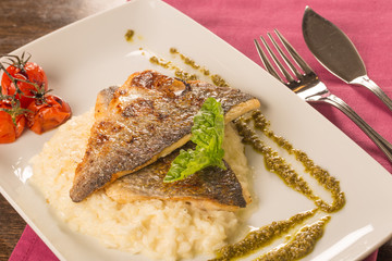 Grilled trout with risotto, tomatoes, and pesto