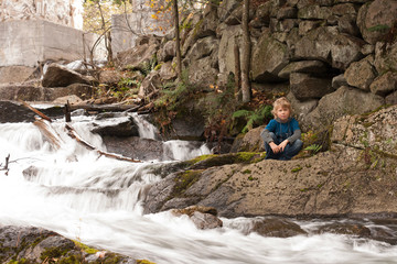 Fototapeta na wymiar Young teen sitting by the stream