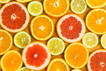 Citrus fruit background with sliced f oranges lemons lime tanger