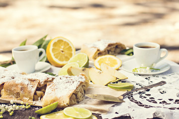 pie, strudel with pear and lemon. Cup of coffee. .Picnic, Breakfast in nature. Food in nature.