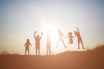 Silhouette Children playing on summer sunset happy time
