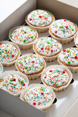 Cupcake packaging, delivery box, vanilla cupcakes with white glaze, selective focus, close up