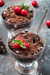 Chocolate desserts with cherries in glasses,dark background, selective focus, close up