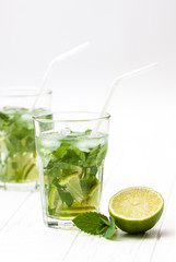 Fototapeta premium Mohito mojito drink with ice mint and lime on wooden white table.