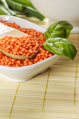 Orange lentils in white bowl