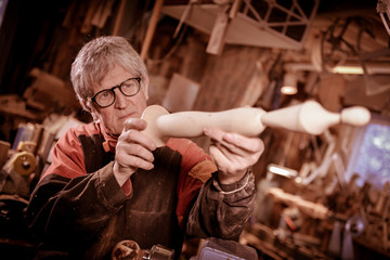 Obraz na płótnie Canvas Woodturners using a rotating clamp to turn the wood.