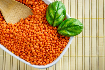 Orange lentils in white bowl