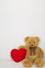 Brown teddy bear with soft heart