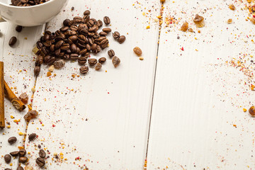 Coffee Beans, Cinnamon and Brown on Light White Wooden Table, free Space for Text
