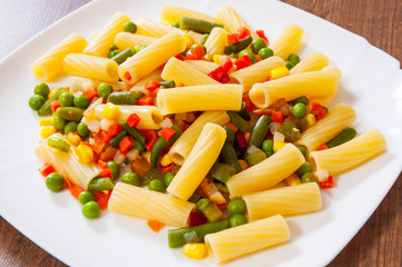 rigatoni pasta with mixed vegetables on white plate