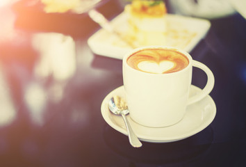 White cups of Cappuccino coffee with heart shaped milk foam. Sel
