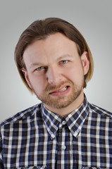 Obraz premium Young man grimace.