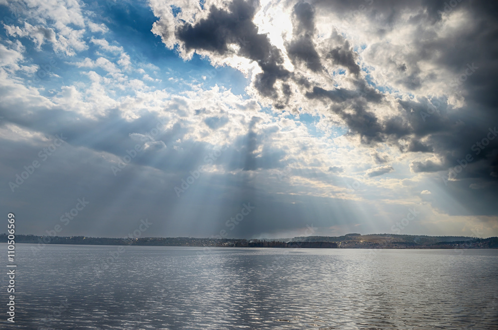 Wall mural rays of sun shining through the clouds.