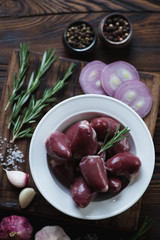 Raw fresh seasoned turkey hearts, above view, close-up