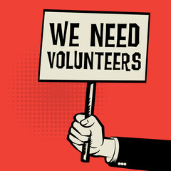 Poster in hand, business concept with text We Need Volunteers