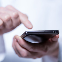 Close-up of hands of doctor using phone