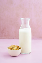 Fresh homemade walnut milk in a bottle with fresh walnuts