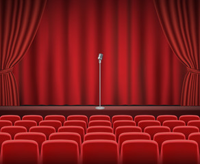 Rows of red cinema or theater seats in front of show stage with retro microphone