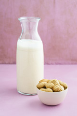 Fresh homemade peanut milk in a bottle with fresh peanuts