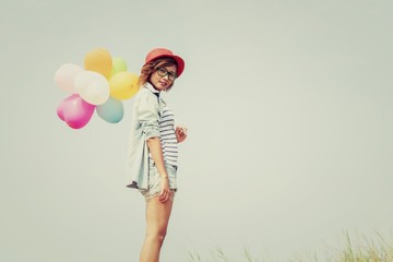 young beautiful woman holding balloon very happy on the fresh ai