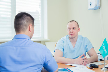 Obraz premium Male Patient Having Consultation With Doctor In Office