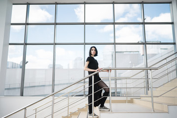Fototapeta na wymiar Portrait of black-haired woman on stairway
