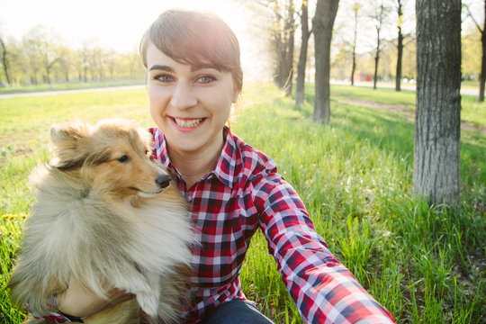 young woman taking selfie with her dog