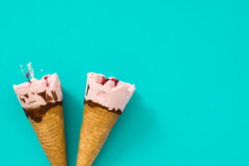 Strawberry ice cream cones on blue background
