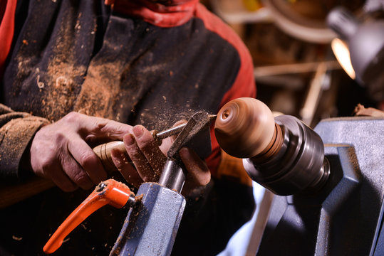Wood turners using a rotating clamp to turn the wood.