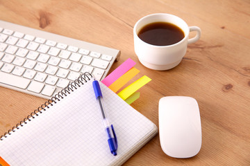 Office table with blank notepad and laptop 