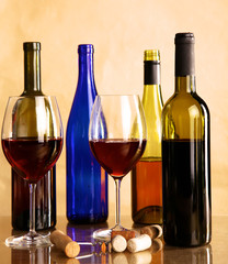 wine bottle and wine glass on a glass table