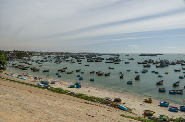 Fishing village and colorful fishing boats near Mui Ne at a sunny day. Vietnam